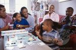 family having fun playing Monopoly