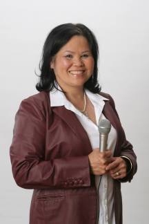 Ha Tran, standing and smiling