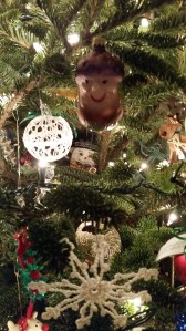 Snowman hidden carefully in the tree boughs 